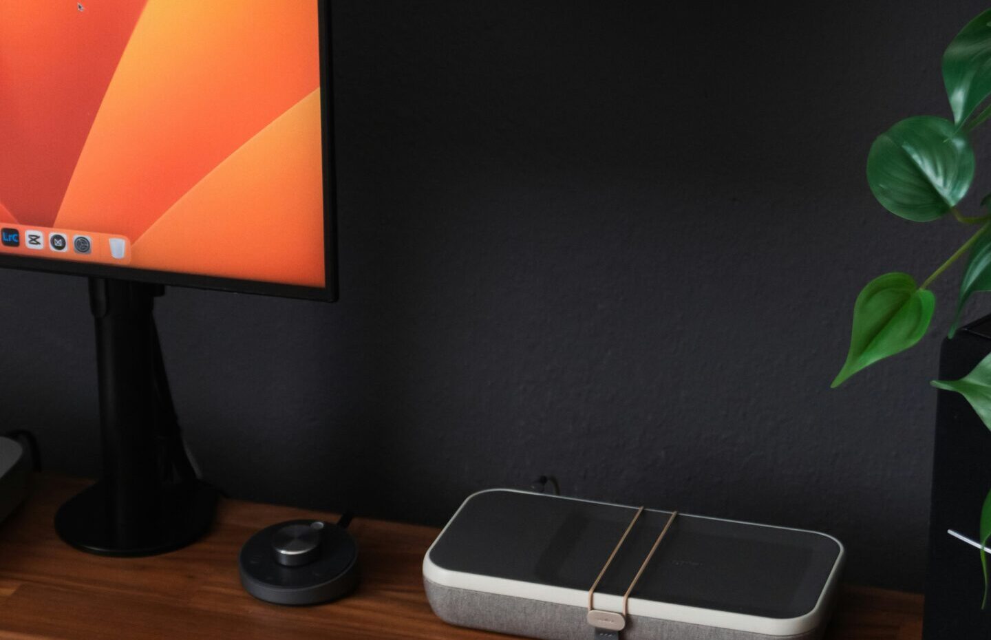 a desk with a laptop, keyboard, mouse and a monitor