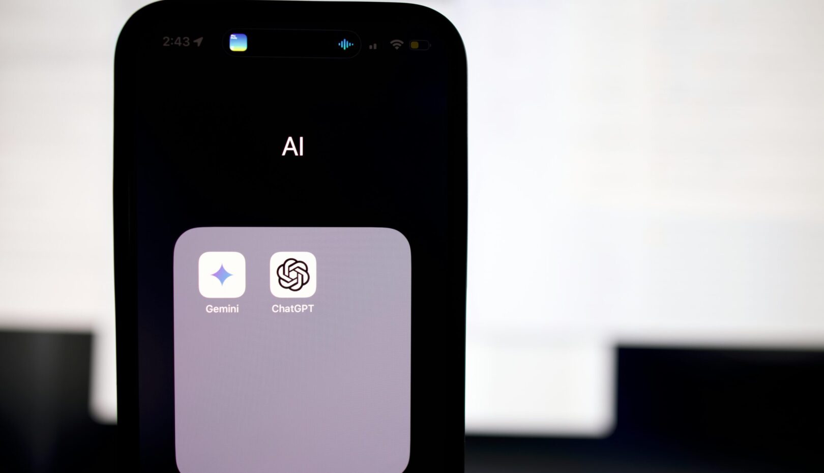 a close up of a cell phone with an ai button