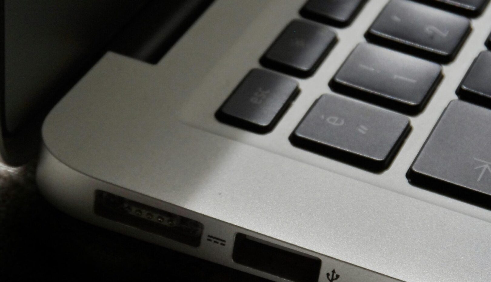 Free Detailed view of a silver laptop showing keyboard and multiple ports. Stock Photo